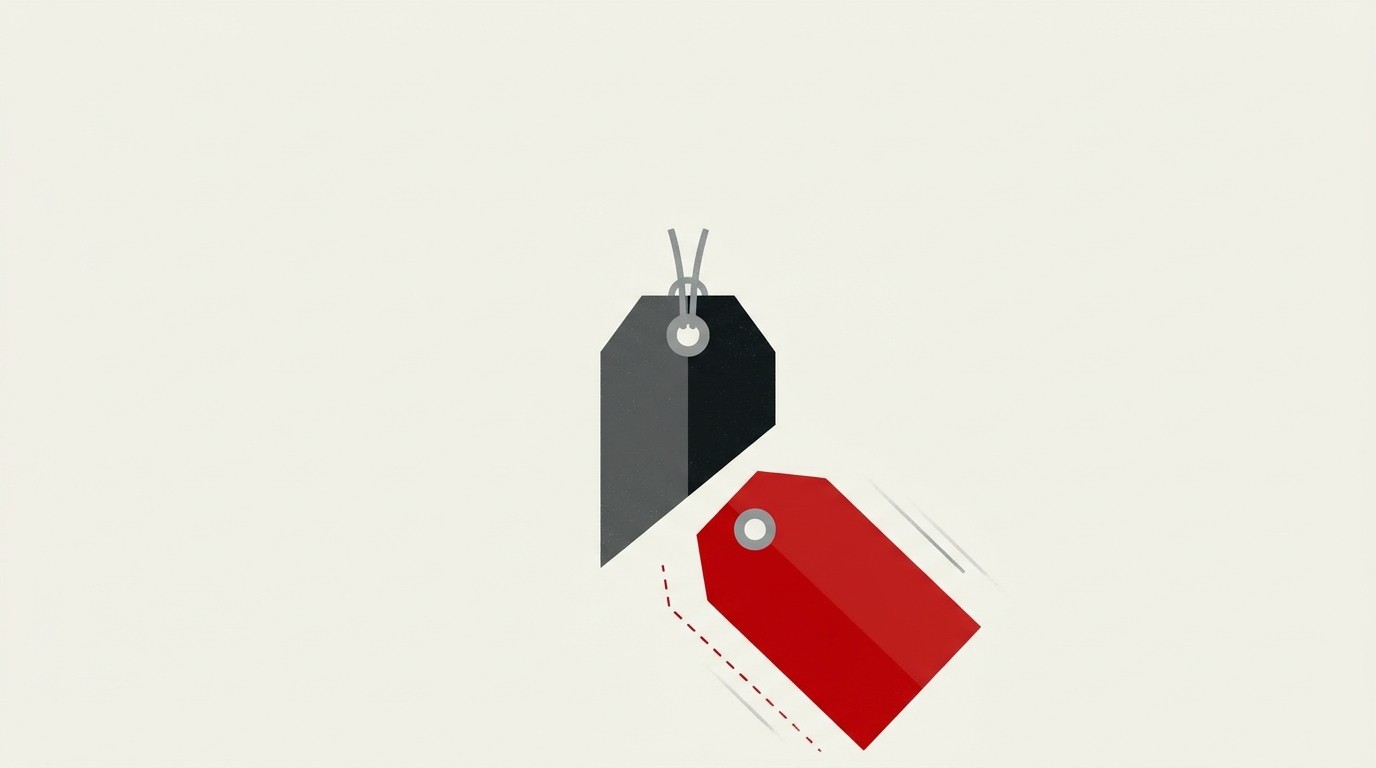 A cream background with a single red price tag cut in half, one half falling away