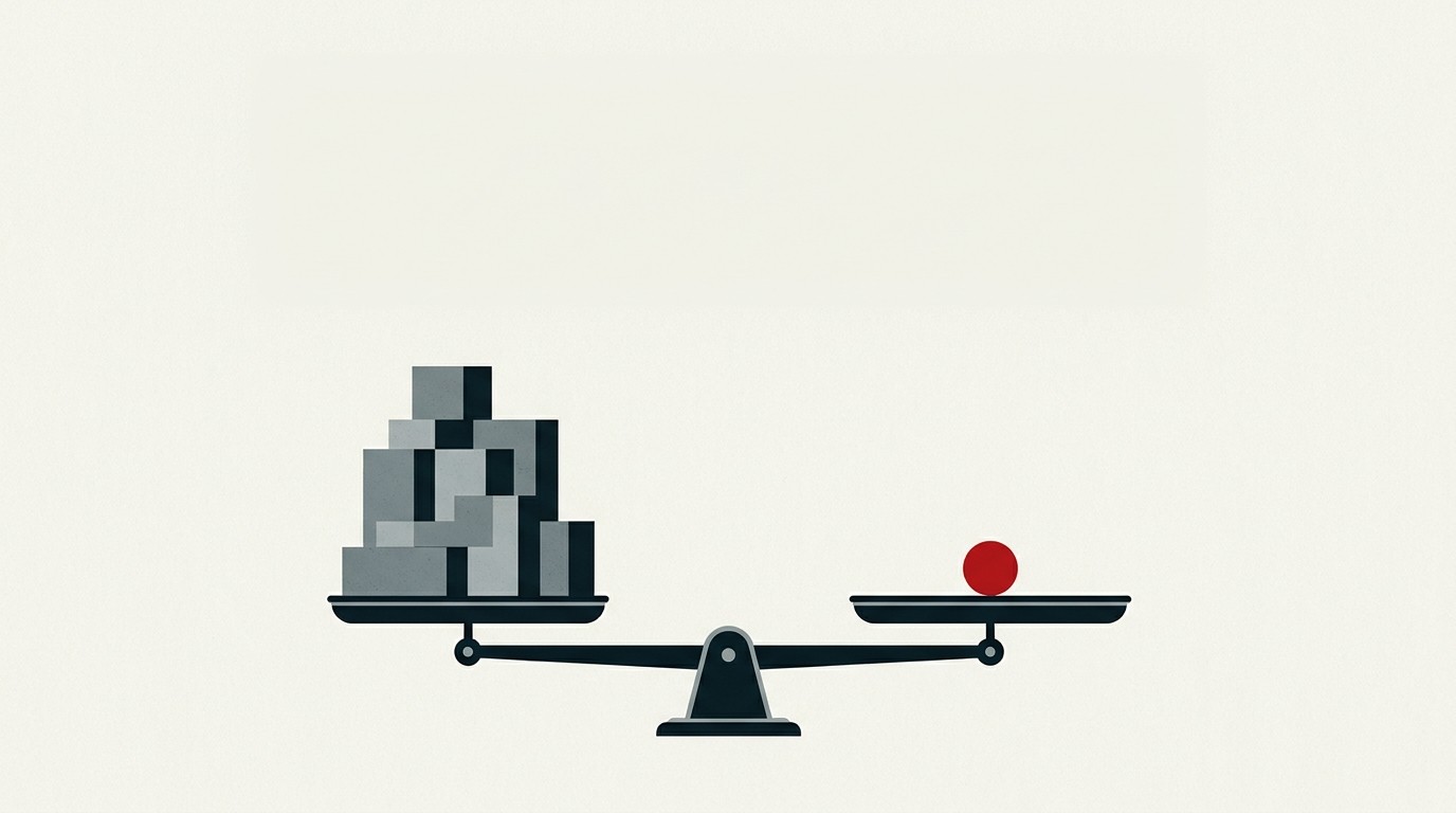 A pristine cream-colored balance scale with one red novelty coin weighed against stacked grey blocks