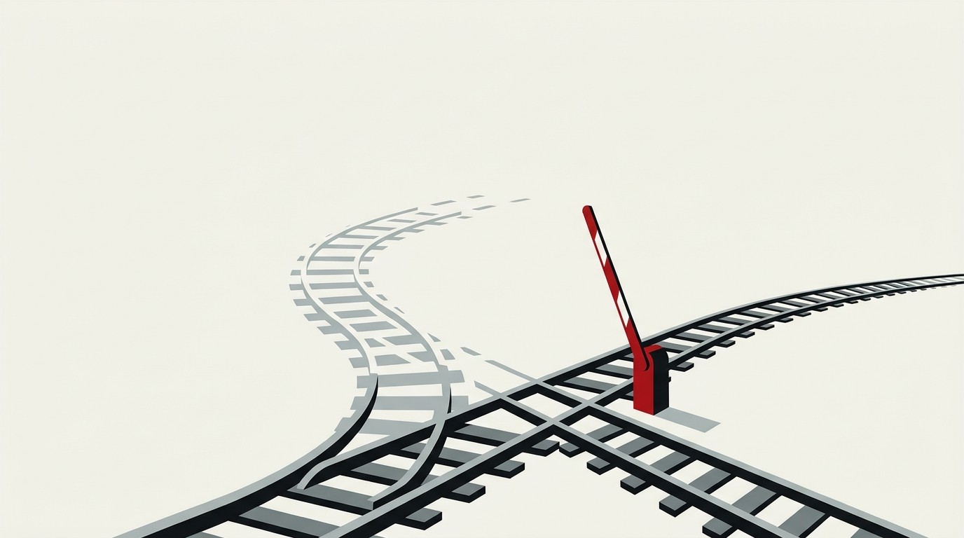 A cream background with a single red toll gate arm lifting over two parallel rail tracks that diverge, one track fading out